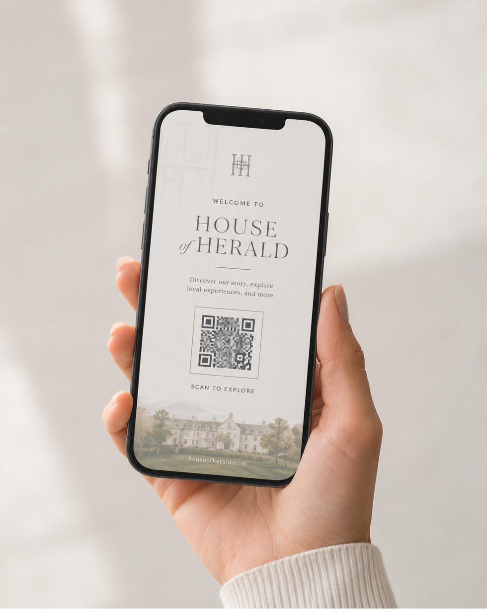 Hand holding a phone with a QR code invitation